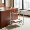 A rolling cart with office supplies next to a wooden desk. Voir les images du produit