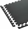 A close-up, angled view of interlocking black puzzle mats on a white background. Voir les images du produit
