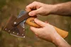 Hands holding a camping axe with a leather sheath. Anteprima dell’immagine prodotto