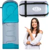 A woman points to a sleeping bag and its carrying case. Náhľad obrázku produktu