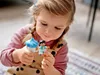 A young girl playing with LEGO DUPLO figures. Podgląd zdjęcia produktu