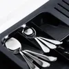 Spoons are neatly arranged in a black cutlery organizer. Náhled obrázku produktu