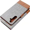 A grey and brown flip case for a smartphone, shown from a diagonal angle. Anteprima dell’immagine prodotto