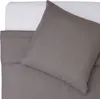 A close-up view of a pillow and bedding. Produktbild-Vorschau