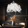 A modern dining room with a pendant light, table, chairs, and a vase of flowers. Produktbild-Vorschau