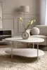 A modern living room setting with a coffee table and a sofa. Produktbild-Vorschau