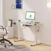 A modern home office setup with a white standing desk, computer, and chair. Voir les images du produit