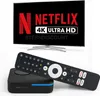 A television screen displaying Netflix and 4K Ultra HD, with a streaming box and remote control in the foreground. Produktbild-Vorschau
