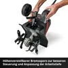 A person's hands are shown adjusting the wheels of a tiller, with the tilling mechanism visible. Produktbild-Vorschau