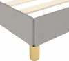 Close-up of a bed frame corner with wooden slats and a gold leg. Náhled obrázku produktu