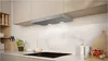 A modern kitchen scene featuring a sleek range hood installed above a stovetop. Produktbild-Vorschau