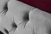 A close-up view of a tufted headboard and mattress of a bed. Náhled obrázku produktu