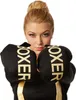 A woman wearing boxing gloves and a black and gold outfit, posing for a photo. Produktbild-Vorschau
