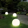 A garden path illuminated by three glowing spherical lights at dusk. Produktbild-Vorschau