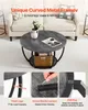A round coffee table with a lower shelf is shown in a living room setting, with text overlays highlighting its features. Voir les images du produit