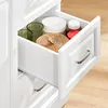 An open drawer of a white cabinet, showing storage items. Podgląd zdjęcia produktu