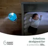 A baby humidifier is placed on a wooden floor next to a crib where a baby is sleeping. Produktbild-Vorschau