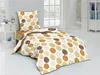 A neatly made bed with a duvet and pillow featuring a circular pattern, set in a bright bedroom. Produktbild-Vorschau