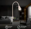 A close-up of a beige LED wall lamp with a flexible arm, mounted on a clamp, in a dimly lit room setting. Náhled obrázku produktu
