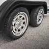 A close-up of two wheels on a trailer, showing the tires and rims. Produktbild-Vorschau