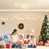 A family is opening Christmas presents in a living room decorated for the holidays. Voir les images du produit