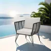 A single outdoor lounge chair with cushions is placed on a white patio overlooking a body of water and islands. Voir les images du produit