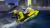 A small LEGO boat is speeding through the water at night, with city buildings in the background. Anteprima dell’immagine prodotto