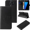 Collage of images showing a black flip phone case with floral and butterfly embossing, and a Samsung Galaxy S7 edge phone inside. Produktbild-Vorschau