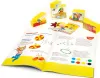 An open book with diagrams and text, surrounded by yellow blocks and other small items, suggesting an educational or craft kit. Náhled obrázku produktu