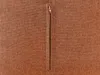 A close-up view of a brown fabric with a zipper. Náhled obrázku produktu
