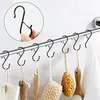 Several S-hooks hanging on a towel bar, with bath accessories hanging from them. Produktbild-Vorschau