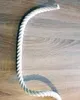A white rope is laid out on a wooden surface in a curved shape. Podgląd zdjęcia produktu