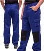A person wearing blue work pants with black knee patches. Produktbild-Vorschau