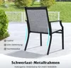 An outdoor chair on a patio with a grassy background and a white fence. Produktbild-Vorschau