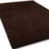 A dark brown shaggy rug is shown from a diagonal angle on a white background. Anteprima dell’immagine prodotto
