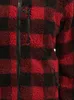 A close-up view of a red and black checkered fleece jacket. Produktbild-Vorschau
