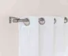 A close-up view of a metal curtain rod with white curtains attached. Produktbild-Vorschau