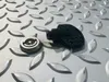 Two metal and plastic parts are placed on a textured metal surface. Produktbild-Vorschau