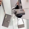 Collage of images showing a gray phone case with a wrist strap and a shoulder strap, featuring card slots and a zippered pocket. Produktbild-Vorschau