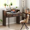 A small desk with a laptop, books, and plants in a home office setting. Náhled obrázku produktu
