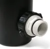 A close-up of a black plastic fitting with a white threaded adapter attached. Produktbild-Vorschau