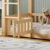Close-up of a wooden bunk bed with a guardrail and a stuffed dog on the mattress. Produktbild-Vorschau