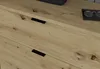 Close-up of a wooden sideboard with two drawers, showing the grain of the wood and black drawer pulls. A pair of glasses in a case is visible on the top surface. Produktbild-Vorschau