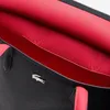 A close-up view of the interior and exterior of a black tote bag with a bright pink lining and handles. Anteprima dell’immagine prodotto