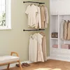 A room with a window, a bench, and a closet with clothes hanging on wall-mounted racks. Produktbild-Vorschau