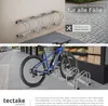 A split image showing a wall-mounted bicycle rack in the top half and a blue bicycle in a floor-mounted rack in the bottom half, with text overlays. Náhled obrázku produktu
