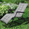 A gray padded lounge chair cushion is placed on a lounge chair in a garden setting. Podgląd zdjęcia produktu