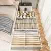 Under-bed storage boxes filled with items, next to a bed. Voir les images du produit