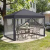 A gray pop-up gazebo with mesh sides is set up on a patio in a backyard, with a table and chairs inside. Podgląd zdjęcia produktu