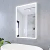 A bathroom with a mirror, bathtub, and plant. Anteprima dell’immagine prodotto